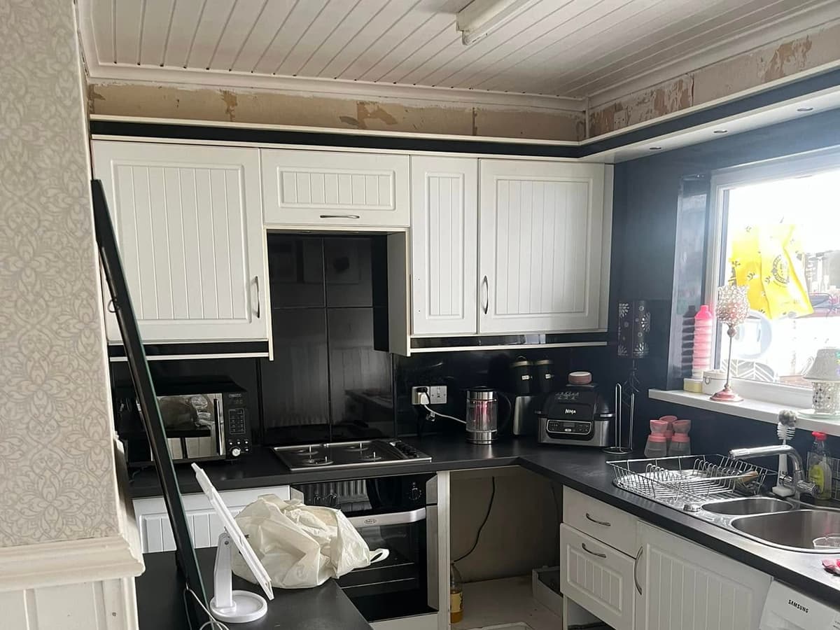 Before: the old black-and-white kitchen part-way through strip-out