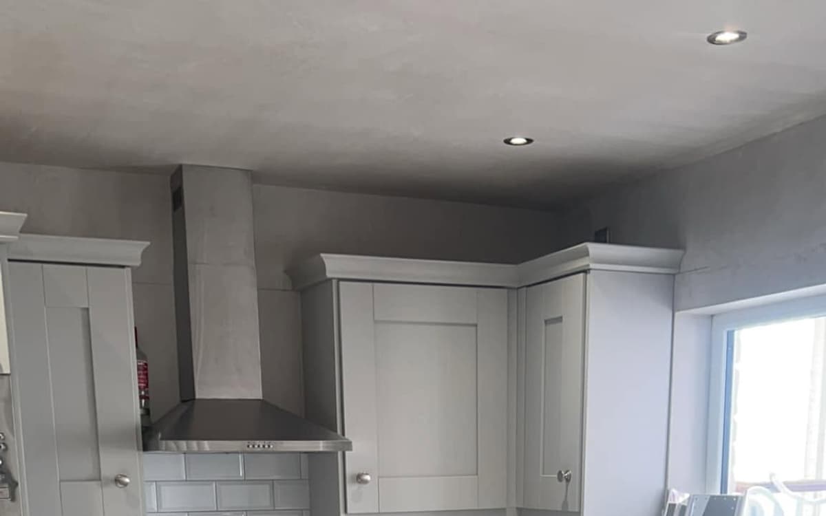 Grey shaker kitchen fitted in Belfast — metro-tile splashback and marble-effect floor
